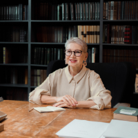 An academics expert female sitting in library