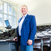 A professional male standing in office